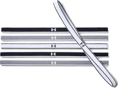 A set of Under Armour headbands laid out horizontally, with one headband angled diagonally across the others.