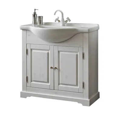 A white wooden vanity cabinet with a sink and faucet.