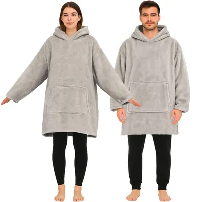 A man and a woman are shown wearing oversized grey hoodie blankets.