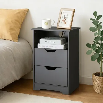 A bedside table next to a bed, with a plant in a basket to the right.