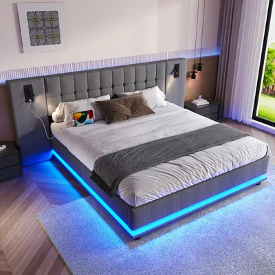 A modern bedroom with a grey upholstered bed featuring LED lighting.