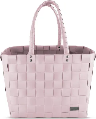 A pink woven basket bag with braided handles, shown against a white background.