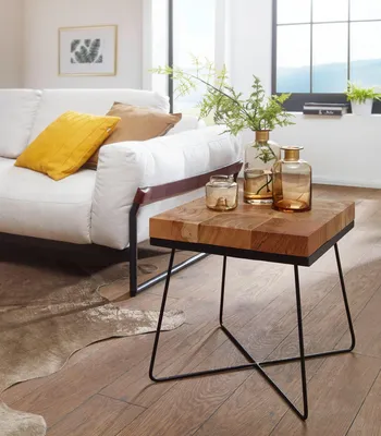 A living room scene with a sofa, a side table, and decorative items.