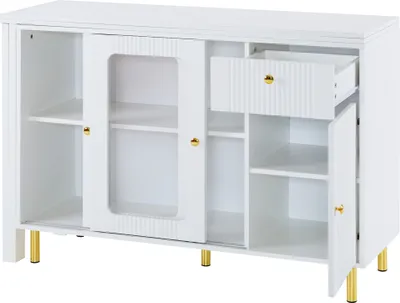 A white sideboard with gold legs and gold handles, shown with its doors and drawer open to reveal storage compartments and shelves.