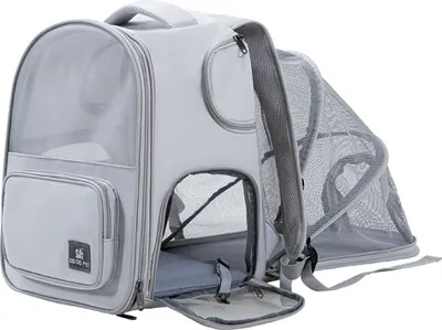 A light gray pet carrier backpack with an expandable mesh section is shown against a white background.