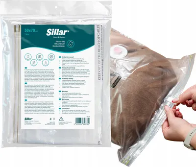 A vacuum bag with clothing inside, being sealed by hands.