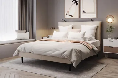 A bedroom scene with a bed, nightstand, and window seat.
