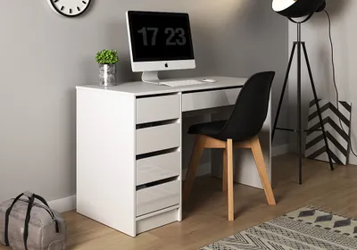 A modern white desk with a computer, chair, and storage drawers, set in a home office or bedroom environment.