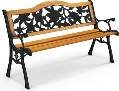 A garden bench with a wooden seat and backrest, and black metal legs and armrests with a floral design.