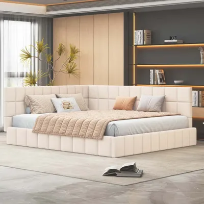 A modern bedroom with a large corner bed.