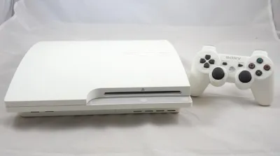 A white PlayStation 3 Slim console and a white controller are displayed on a white background.