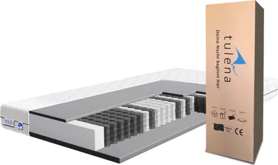 A cutaway view of a mattress next to its packaging.