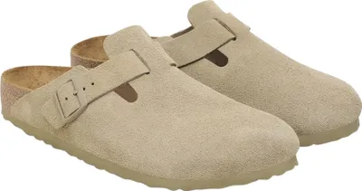 A pair of beige Birkenstock Boston clogs are shown from a slightly elevated side angle against a white background.