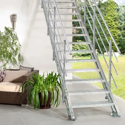 An outdoor staircase with a sofa and plant in the foreground.