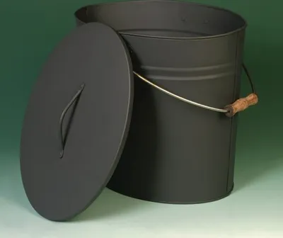 A black oval metal bucket with a lid and a wooden handle, set against a green background.