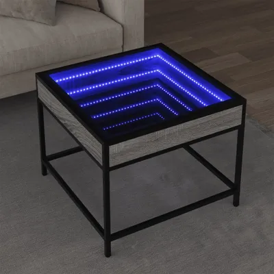 A square coffee table with a wood-grain finish and a black metal frame, featuring an infinity mirror effect with blue LED lights on its surface, placed on a gray rug in a living room setting.