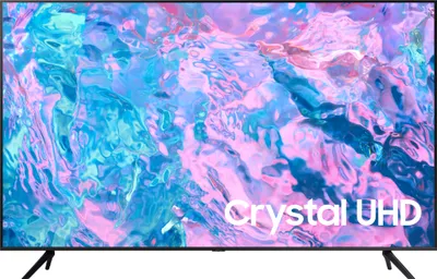 A Samsung Crystal UHD television is displayed front and center, showcasing its screen with a vibrant, abstract image. The TV is supported by two black legs.