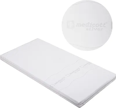 A white mattress with a circular close-up showing the texture and branding.
