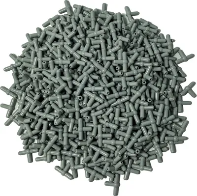 A pile of small, gray, T-shaped connectors.