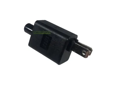 A black electrical adapter with metal prongs on a white background.
