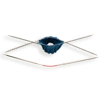 A circular knitting needle with blue yarn being worked on.