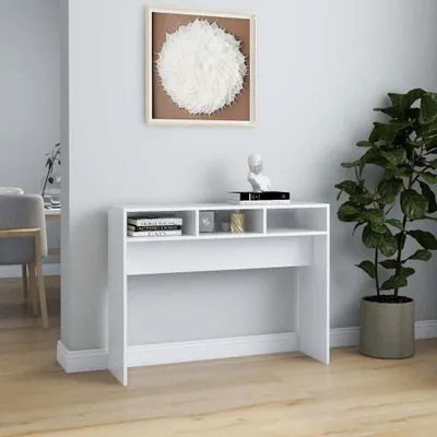 A white console table with shelves is shown in a room.