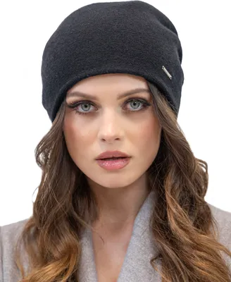 A woman wearing a beanie and coat.
