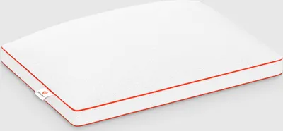A white pillow with red trim on a light gray background.