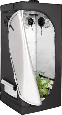 A black grow tent with its front flap partially open, revealing plants inside.