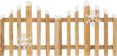 A wooden fence decorated with snowflakes and lights.