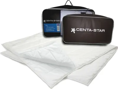 A folded white comforter is shown in front of two branded storage bags.