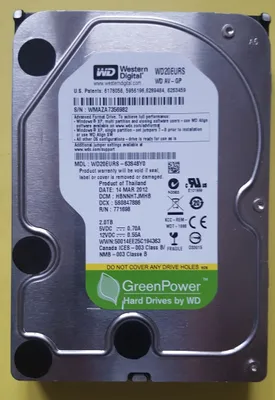 A close-up, top-down view of a Western Digital hard drive with a yellow background.