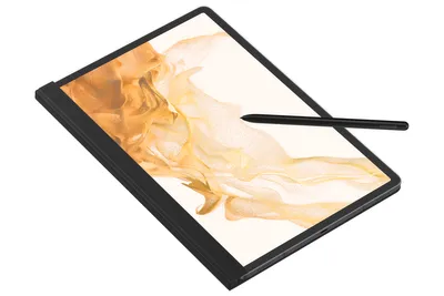 A black tablet with a stylus resting on its screen, which displays abstract golden artwork.