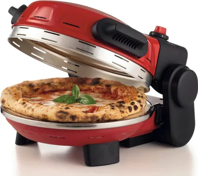 A red pizza oven with a pizza inside.