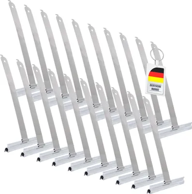 A group of metal rolladen suspension springs arranged diagonally on a white background, with a German flag tag attached to one of them.