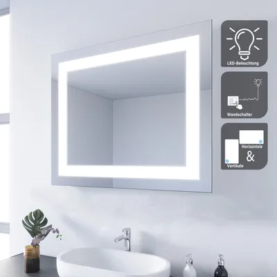 A bathroom scene with a mirror, sink, and faucet.