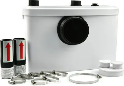 A white macerator pump unit with various accessories, including hose clamps and two cylindrical objects with red arrows, is displayed against a white background.