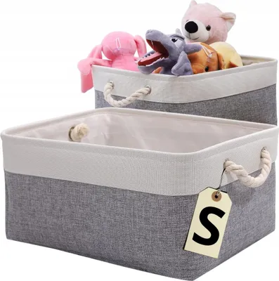 Two storage baskets, one filled with stuffed toys, are shown against a white background. The front basket has a tag with the letter 'S' on it.