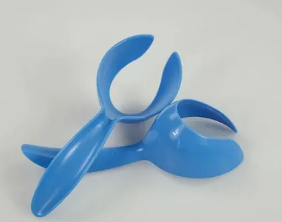 Two blue plastic kitchen utensils are placed on a white background.