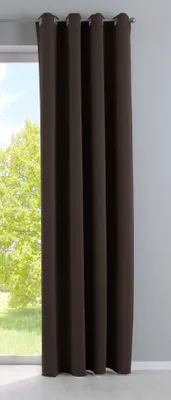 A brown blackout curtain hanging in front of a window.