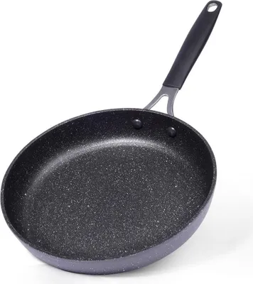 A black frying pan with a speckled surface and a black handle, set against a white background.
