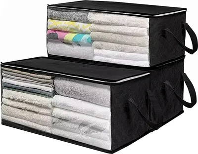 Two stacked fabric storage boxes filled with folded towels and blankets.