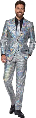 A man wearing a silver disco suit and tie, standing against a white background.