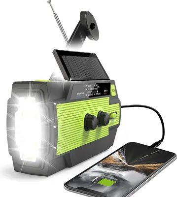 A solar-powered emergency radio with a flashlight and power bank function, charging a smartphone.