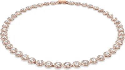 A rose gold necklace with clear stones is displayed on a white background.