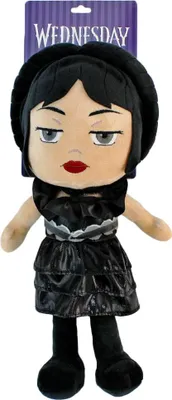 A plush toy of Wednesday Addams is shown standing against a white background.