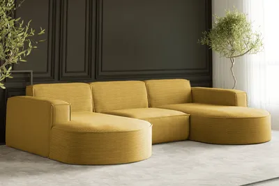 A yellow sectional sofa in a modern living room setting with dark paneled walls and a potted plant.