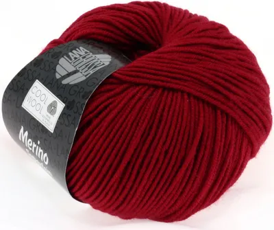 A ball of red yarn with a label wrapped around it.