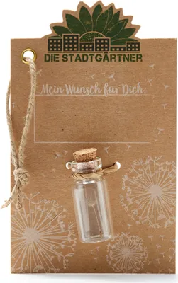A small glass bottle with a cork stopper, tied to a brown card with a string. The card has dandelion illustrations and text.