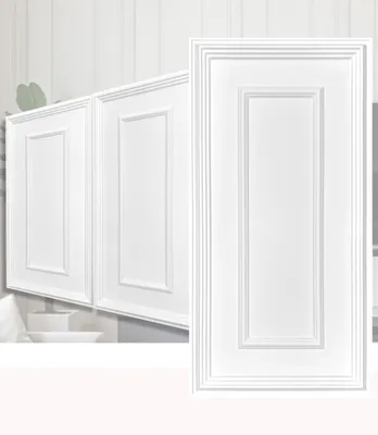 Close-up view of white cabinet doors with decorative paneling.